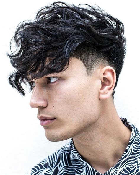 The curly hair taper fade allows guys to start with a low-maintenance, easy haircut on the sides and style their curls into a fringe, textured crop, or messy hairstyle. Use a curl-enhancing cream or strong pomade to control your curly hair fade for a finished look that holds all day.